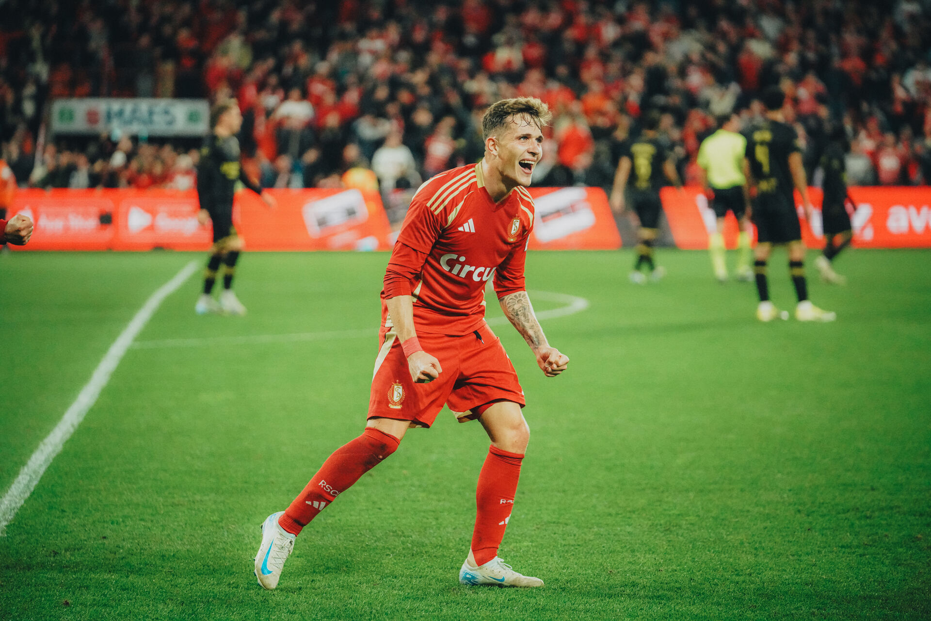 Football player celebrating in a packed stadium